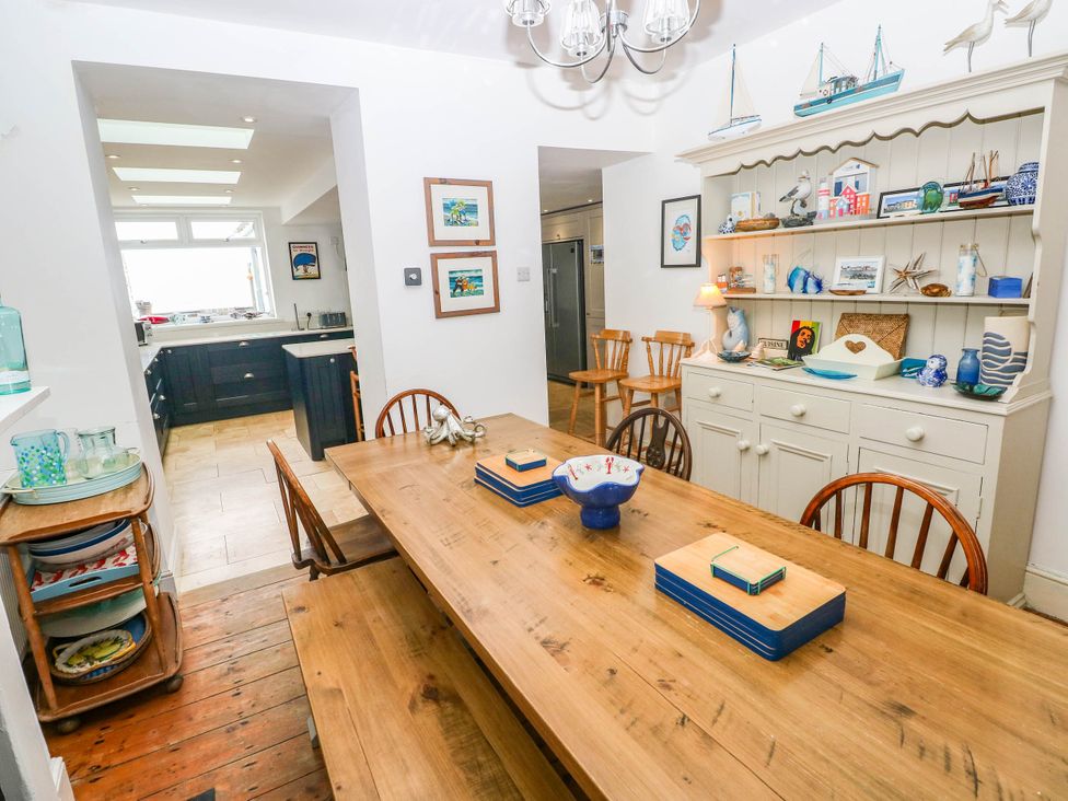 A dining room with a wooden table and chairs at Y Glyn Borth
