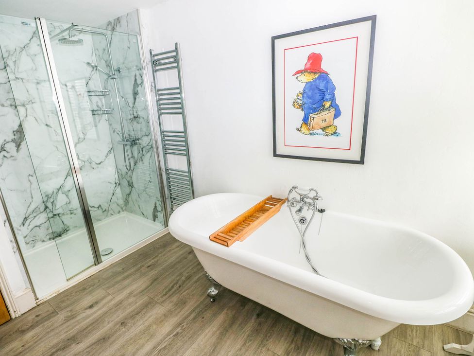 A bathroom with a bathtub and shower at Y Glyn in Borth