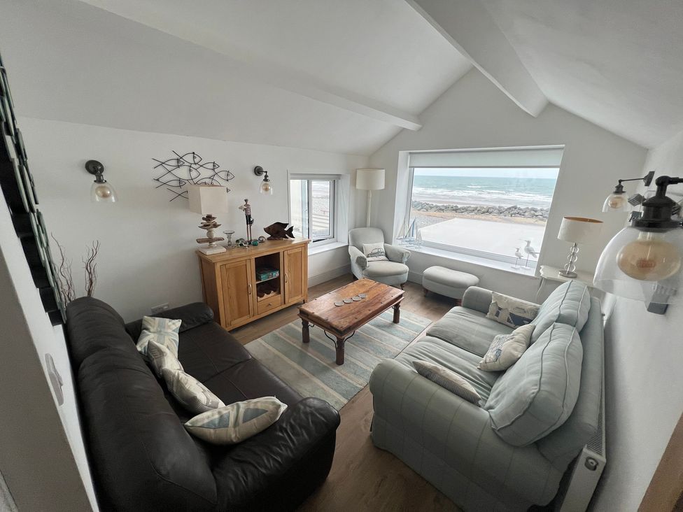 A living room with furniture and a view at Y Glyn in Borth