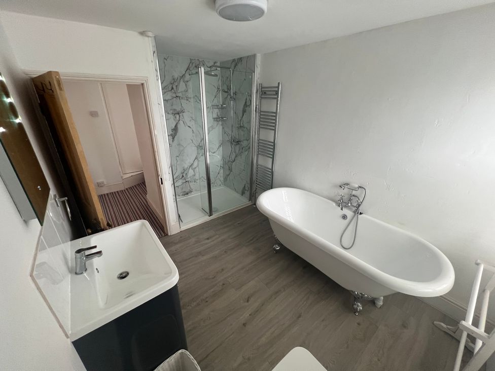 A bathroom with a bathtub and shower at Y Glyn in Borth