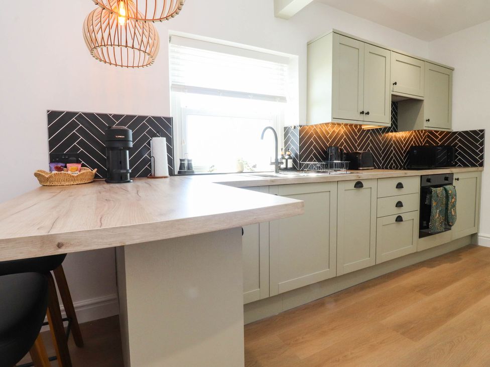 A kitchen with a sink and a coffee machine at The Swallows near Glasson