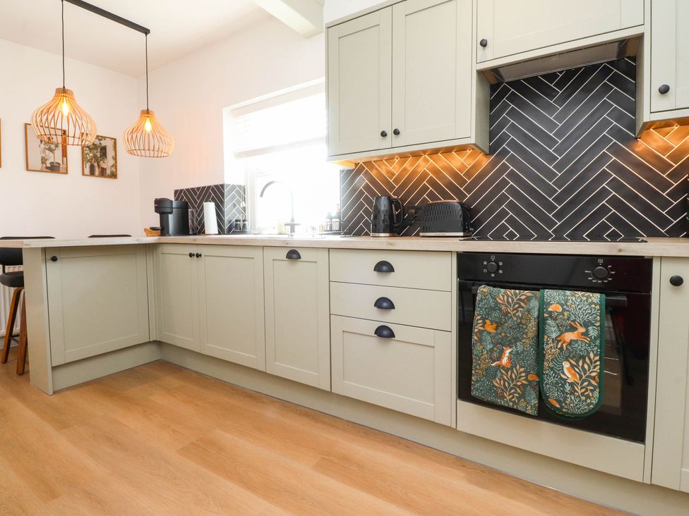 A kitchen with cabinets and appliances at The Swallows near Glasson