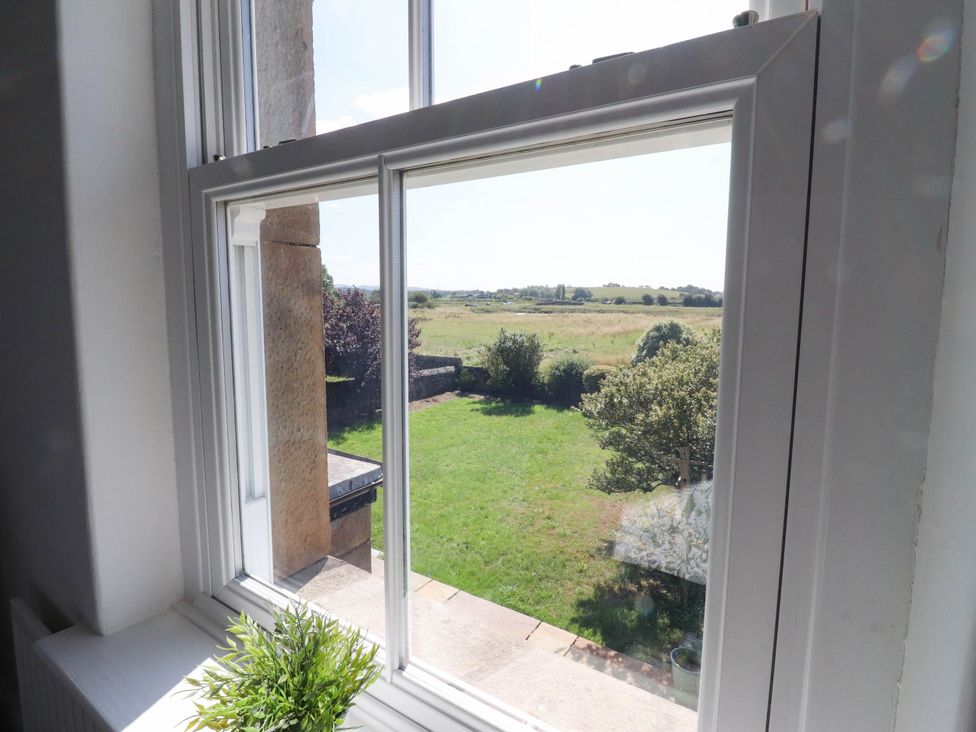 A window showing a garden view at The Swallows near Glasson