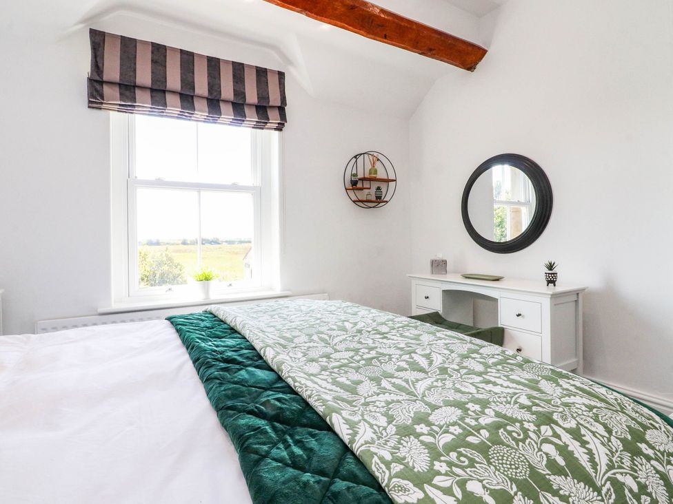 A bedroom with a bed and a desk at The Swallows near Glasson