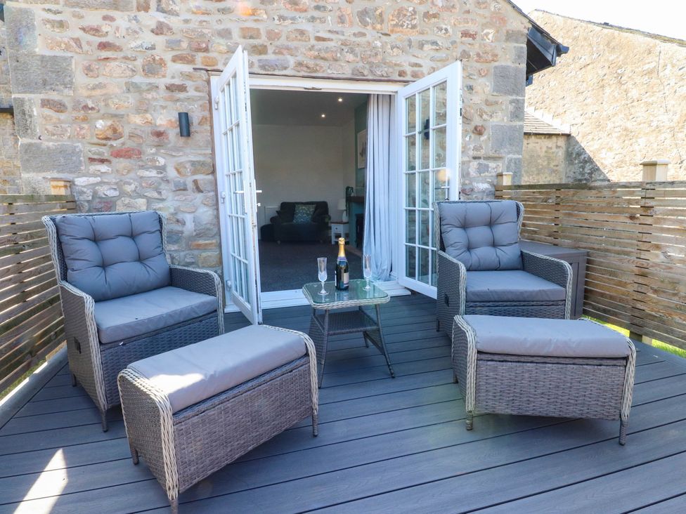 Outdoor seating area with chairs and table at The Swallows near Glasson
