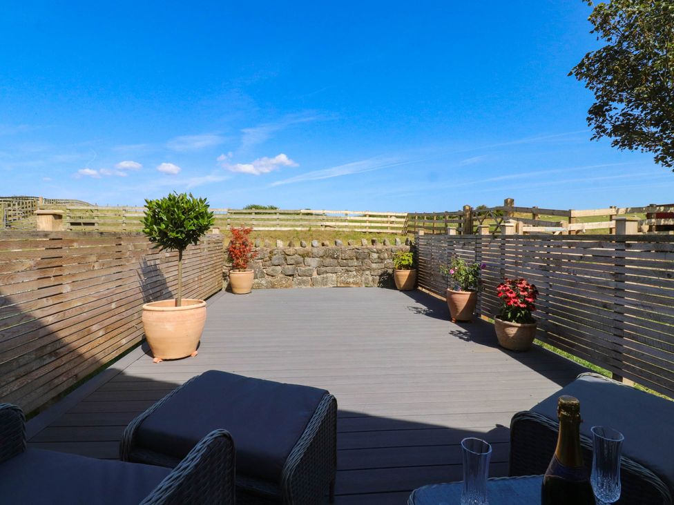 An outdoor area with decking and potted plants at The Swallows near Glasson