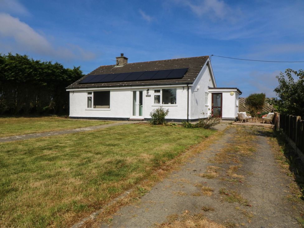 A house with solar panels and a driveway at Wilpol in Llanerchymedd
