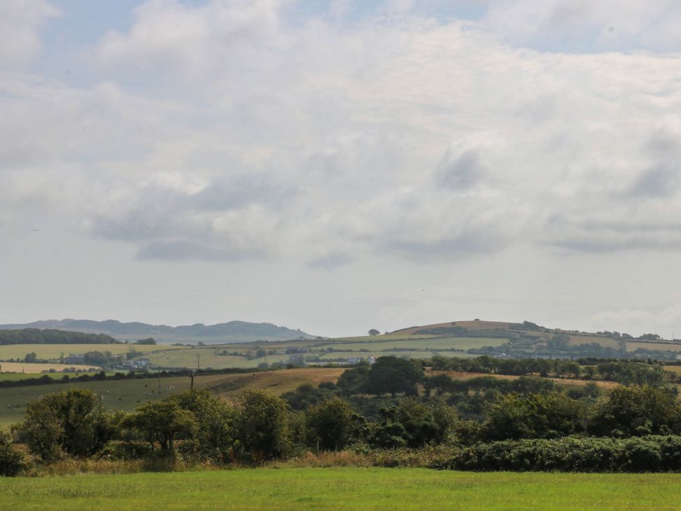 A landscape view with hills and fields at Wilpol in Llanerchymedd
