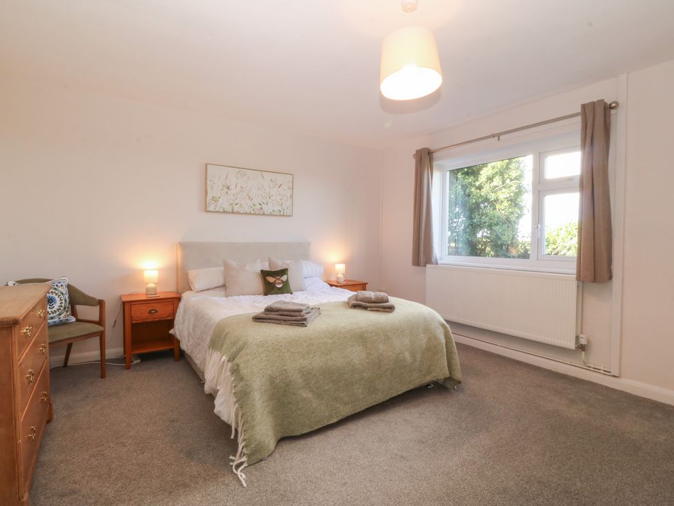 A bedroom with a double bed and bedside table at Wilpol in Llanerchymedd