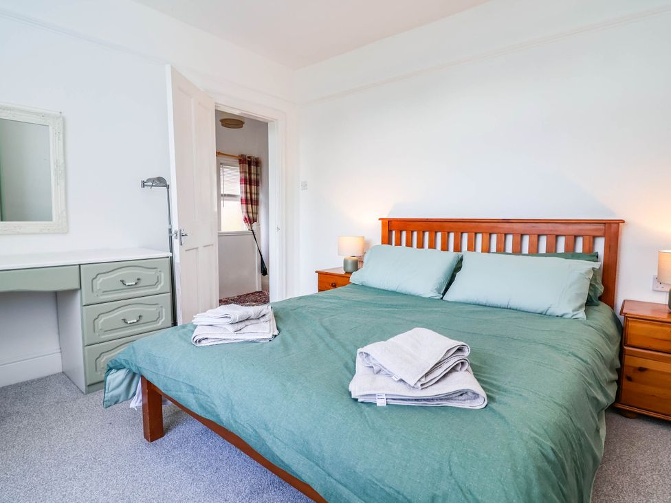 A bedroom with a bed and furniture at 29 Vale Road Ellesmere Port