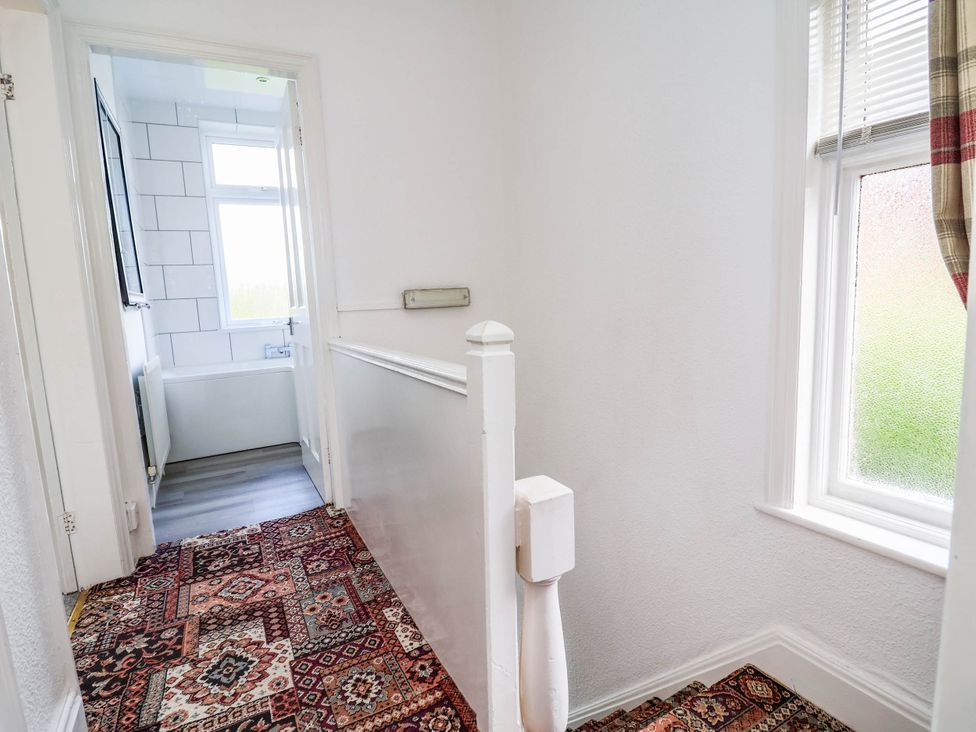 A hallway with a staircase and a bathtub view at 29 Vale Road, Ellesmere Port
