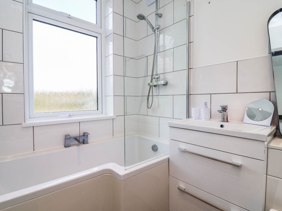 A bathroom with a bathtub and shower at 29 Vale Road in Ellesmere Port