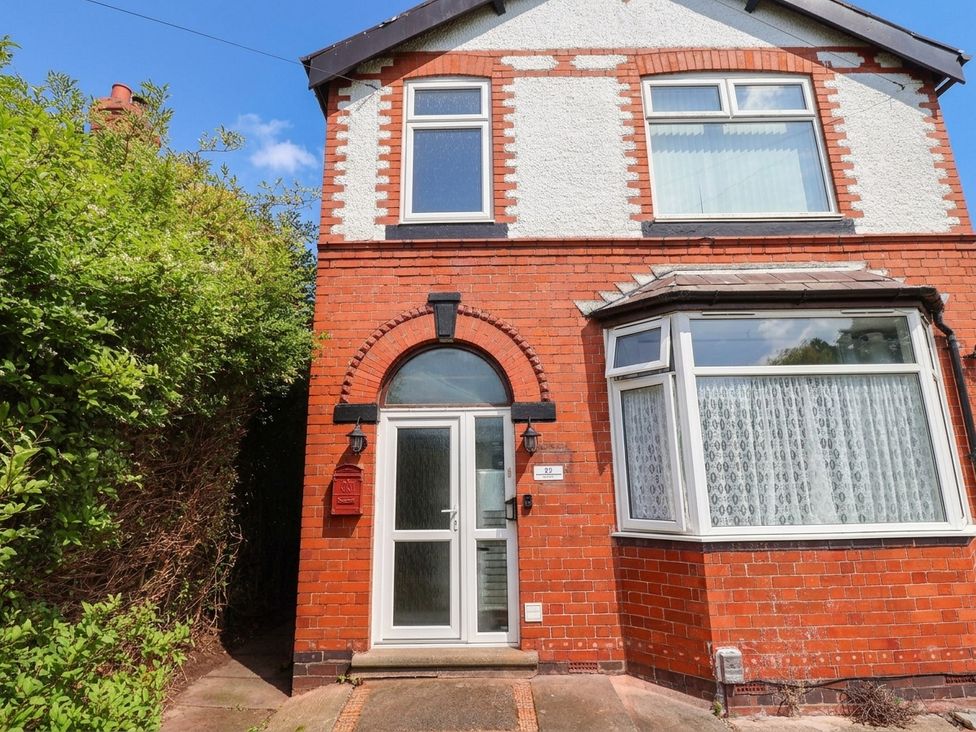 A brick exterior of a house with a front door and windows at 29 Vale Road Ellesmere Port