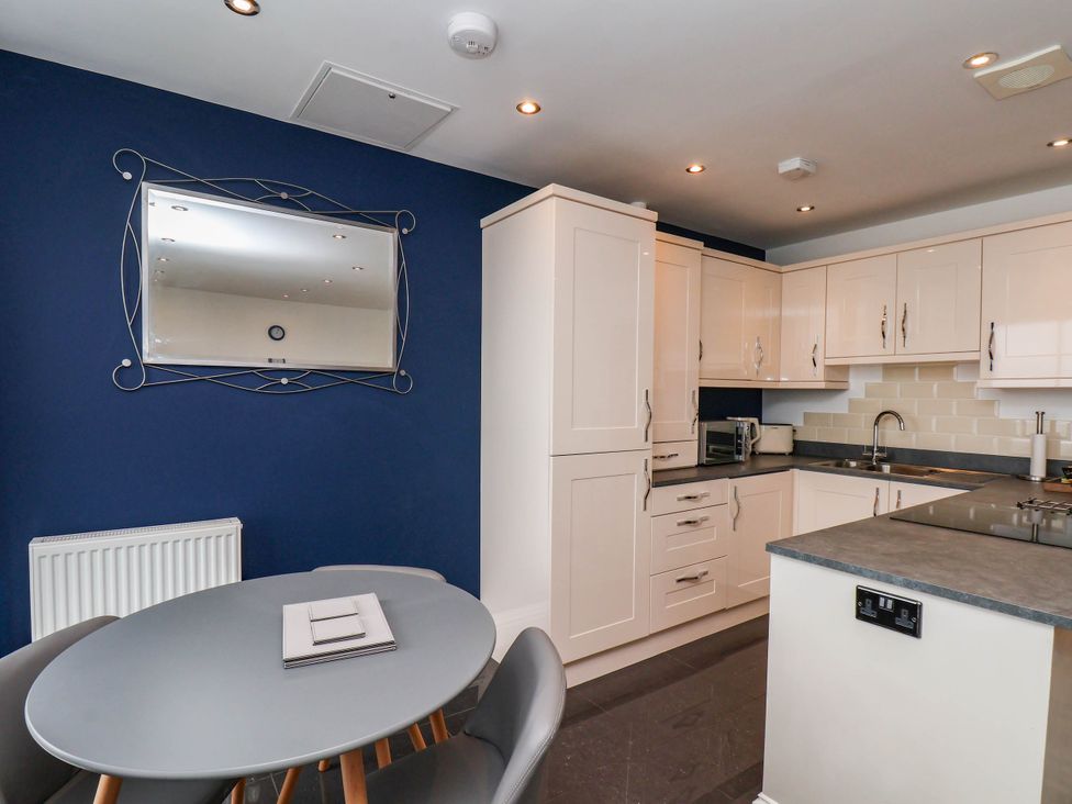 A kitchen with a table and chairs at The Gulls Rest in 