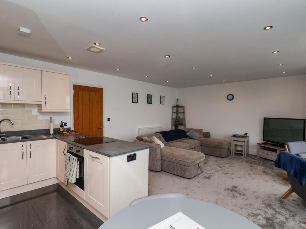 A kitchen and living room with furniture and appliances at The Gulls Rest 