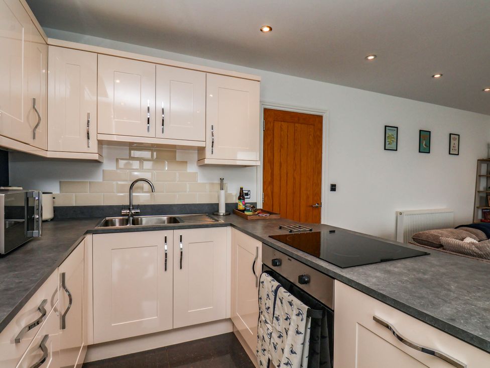 A kitchen with cabinets and a sink at The Gulls Rest 
