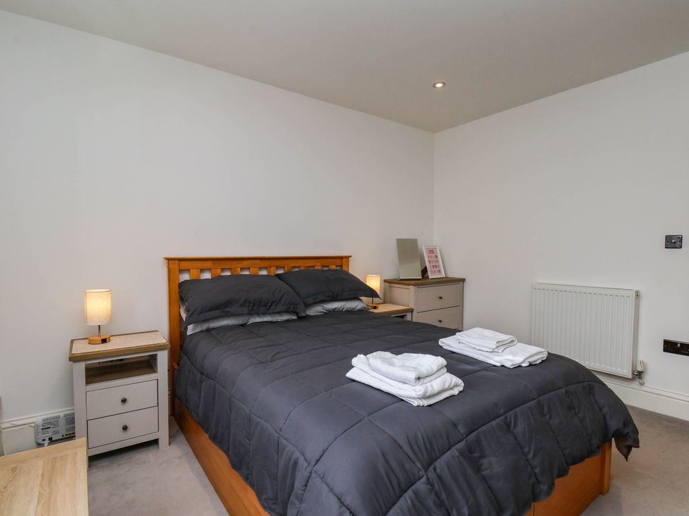A bedroom with a bed and nightstand at The Gulls Rest in 