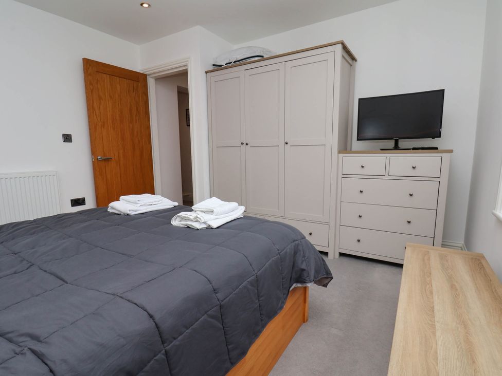 A bedroom featuring a bed, wardrobe, television, and chest of drawers at The Gulls Rest 