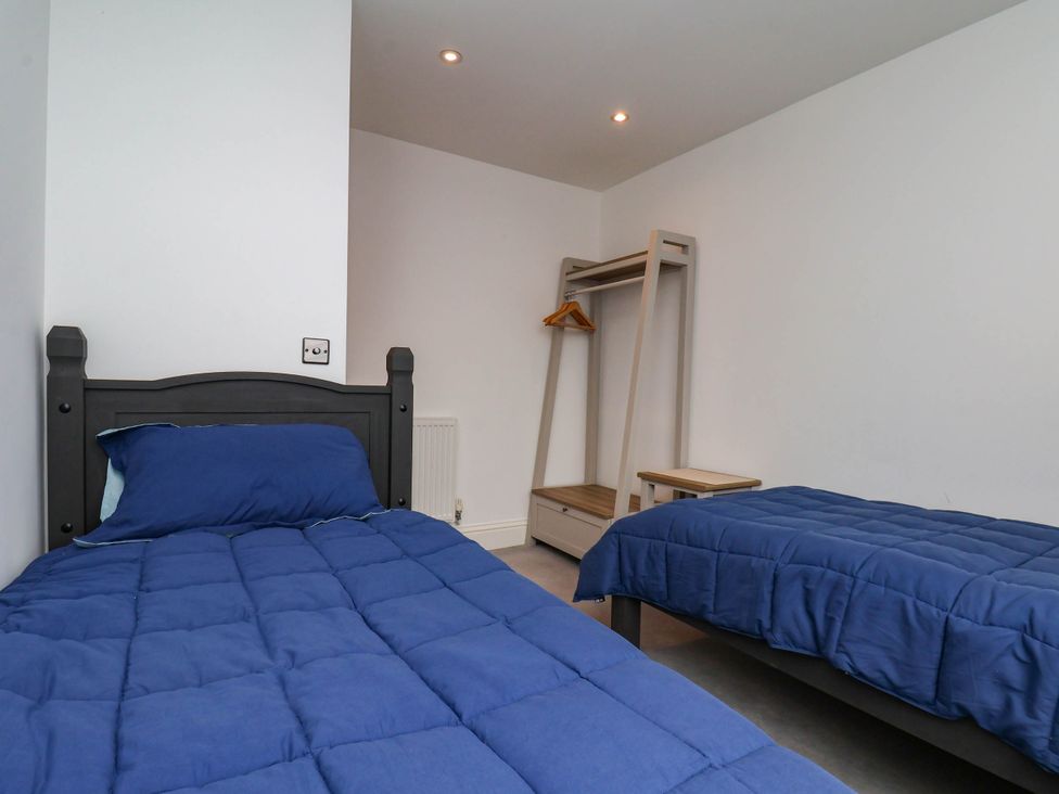 A bedroom with two beds and a hanging rack at The Gulls Rest 