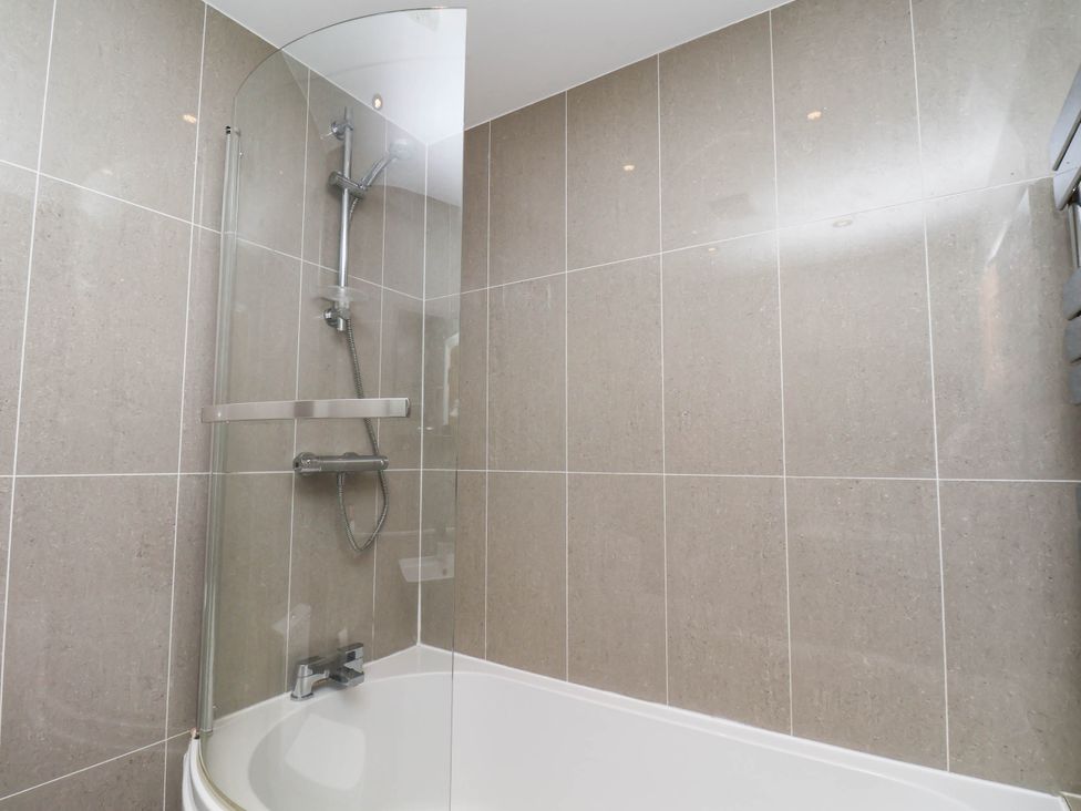A bathroom with a shower and bathtub at The Gulls Rest 