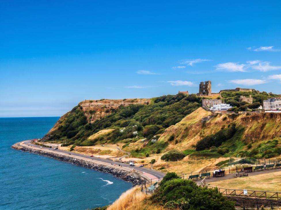 A coastal view with a castle on a hill at The Gulls Rest