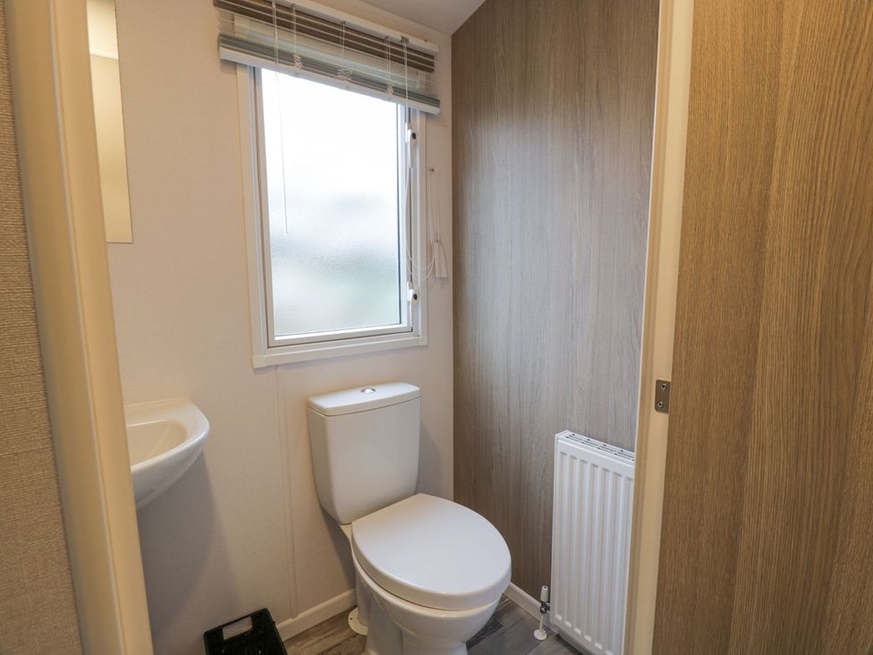 A bathroom with a toilet and sink at Dunskey Way in Portpatrick