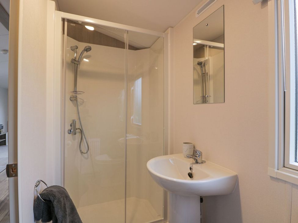 A bathroom with a shower and sink at Dunskey Way in Portpatrick