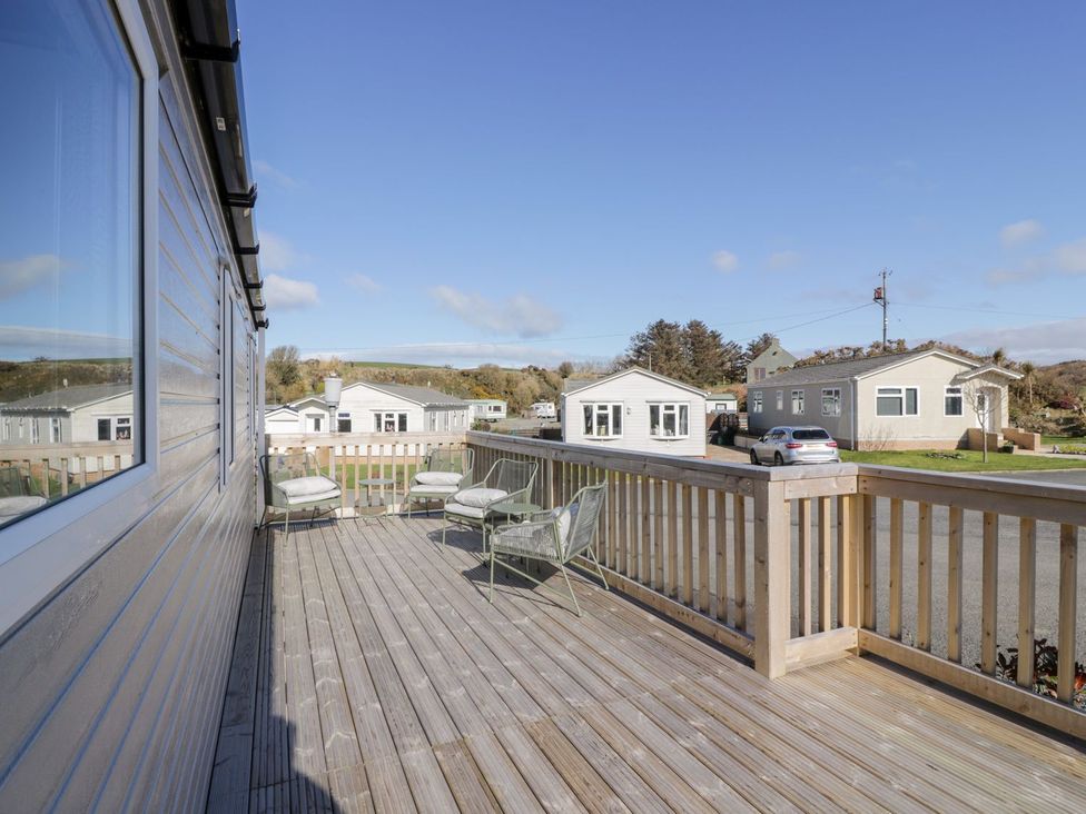 An outdoor terrace with chairs and a view of surrounding homes at Dunskey Way in Portpatrick