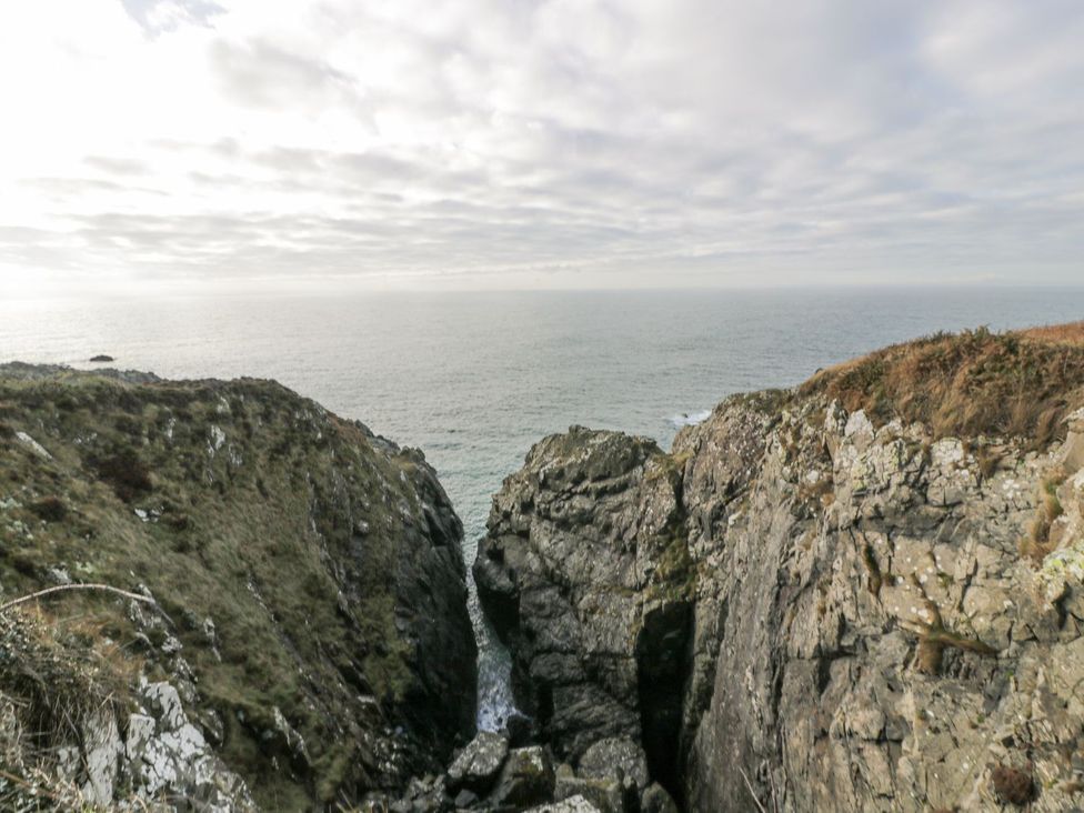 A view of rocky cliffs overlooking the ocean at Dunskey Way in Portpatrick