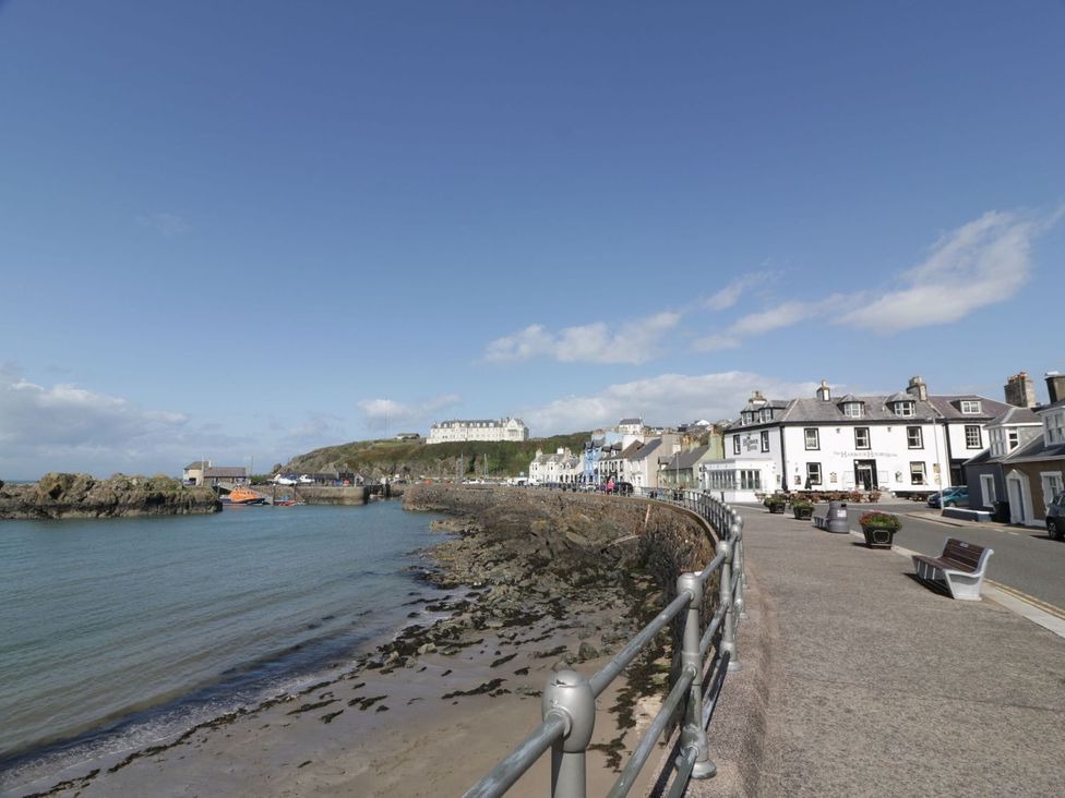 A waterfront promenade with boats and buildings at Dunskey Way in Portpatrick