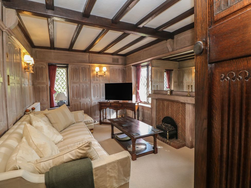 A living room with a sofa and a television at Tudor Lodge near Belper