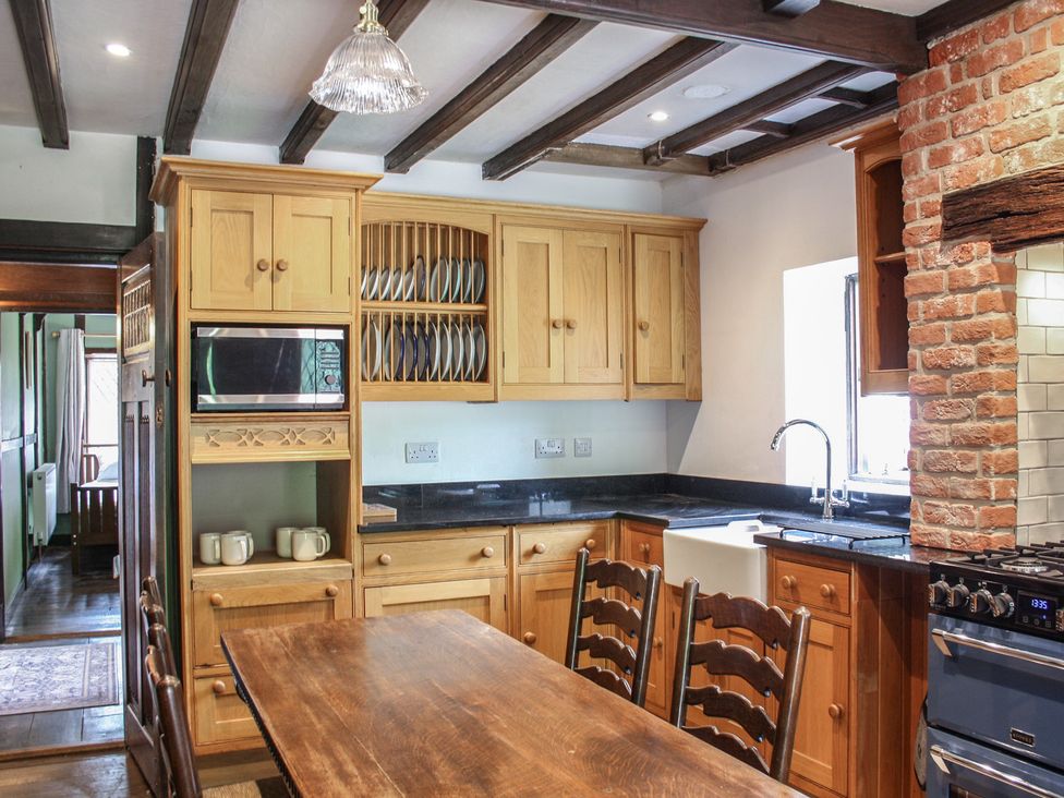 A kitchen with wooden table and chairs at Tudor Lodge near Belper