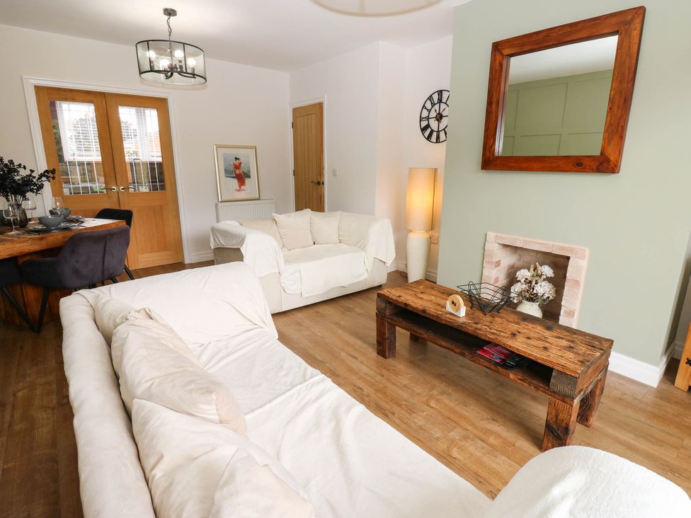 A living room with two sofas and a wooden table at The Greenway in Darlington