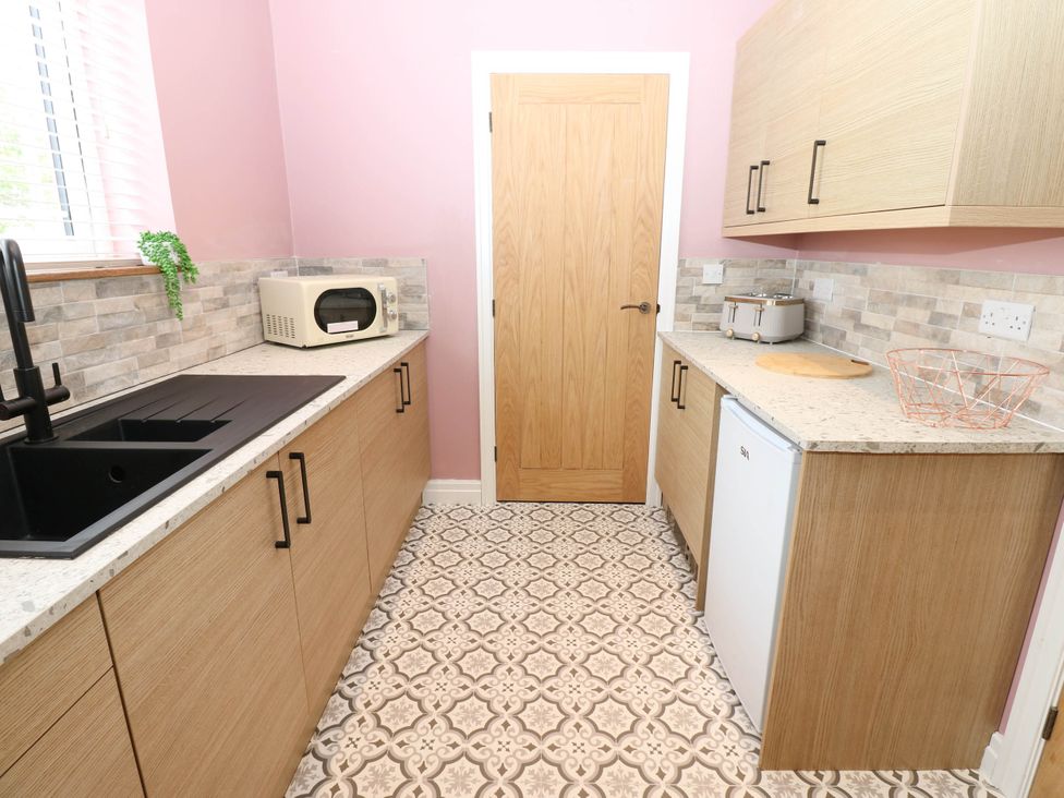 A kitchen with a sink and a microwave at The Greenway in Darlington