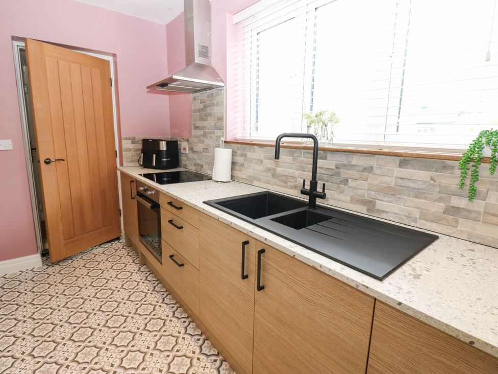 A kitchen with a sink and stove at The Greenway in Darlington
