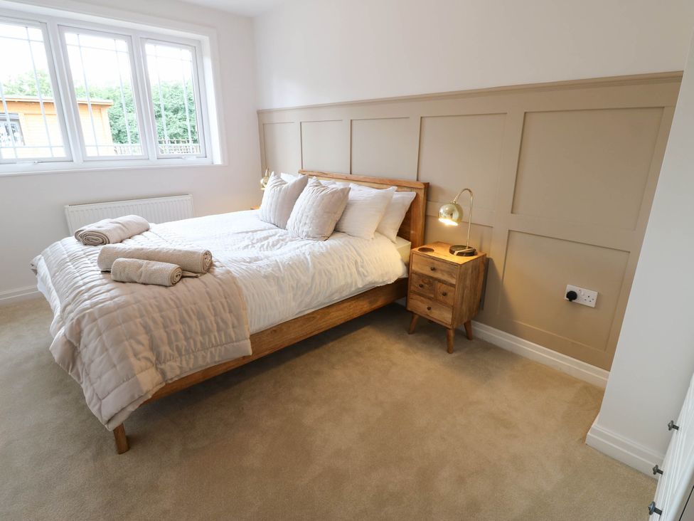 A bedroom with a bed and bedside table at The Greenway in Darlington