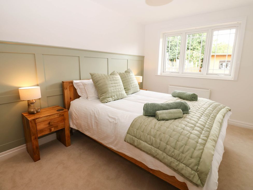 A bedroom with a bed and bedside table at The Greenway in Darlington