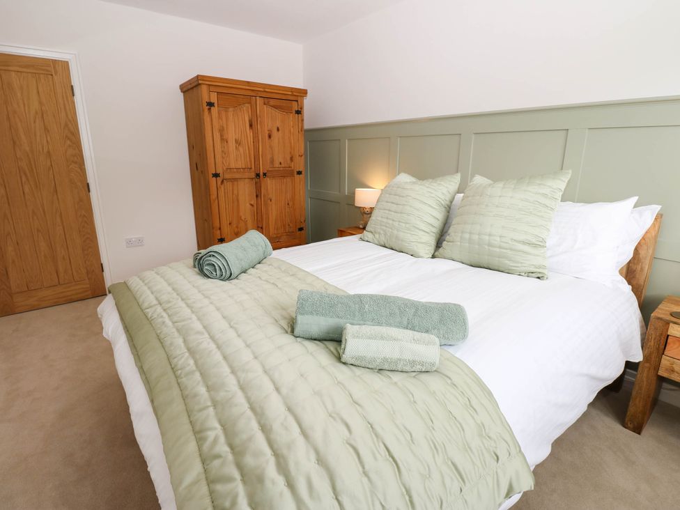 A bedroom with a bed and wardrobe at The Greenway in Darlington