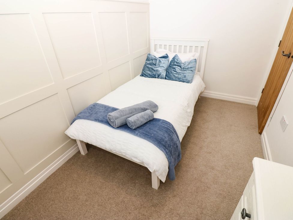 A bedroom with a bed and towels at The Greenway in Darlington