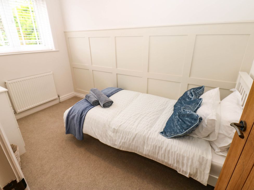 A bedroom with a bed and towel at The Greenway in Darlington