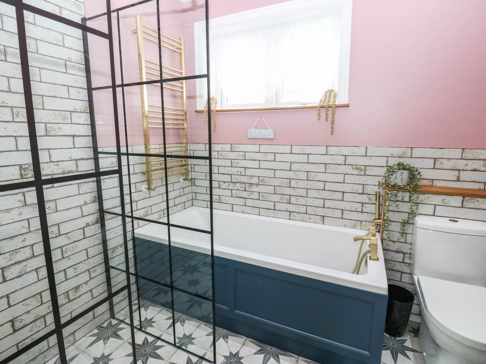 A bathroom featuring a bathtub, toilet, and towel rail at The Greenway in Darlington