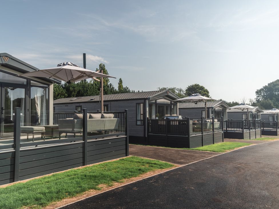 Mobile homes with decking and outdoor furniture at Lakewood Plot 3 St. Osyth