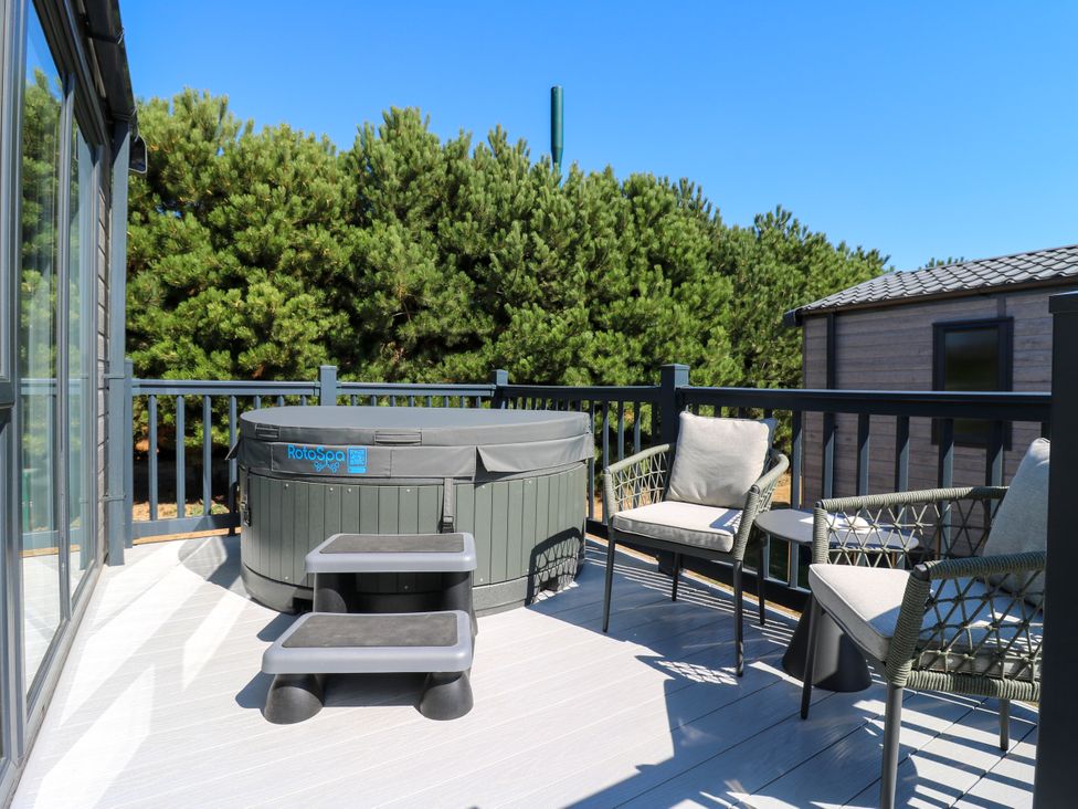 A balcony with a hot tub and outdoor seating at Lakewood Plot 5 St. Osyth