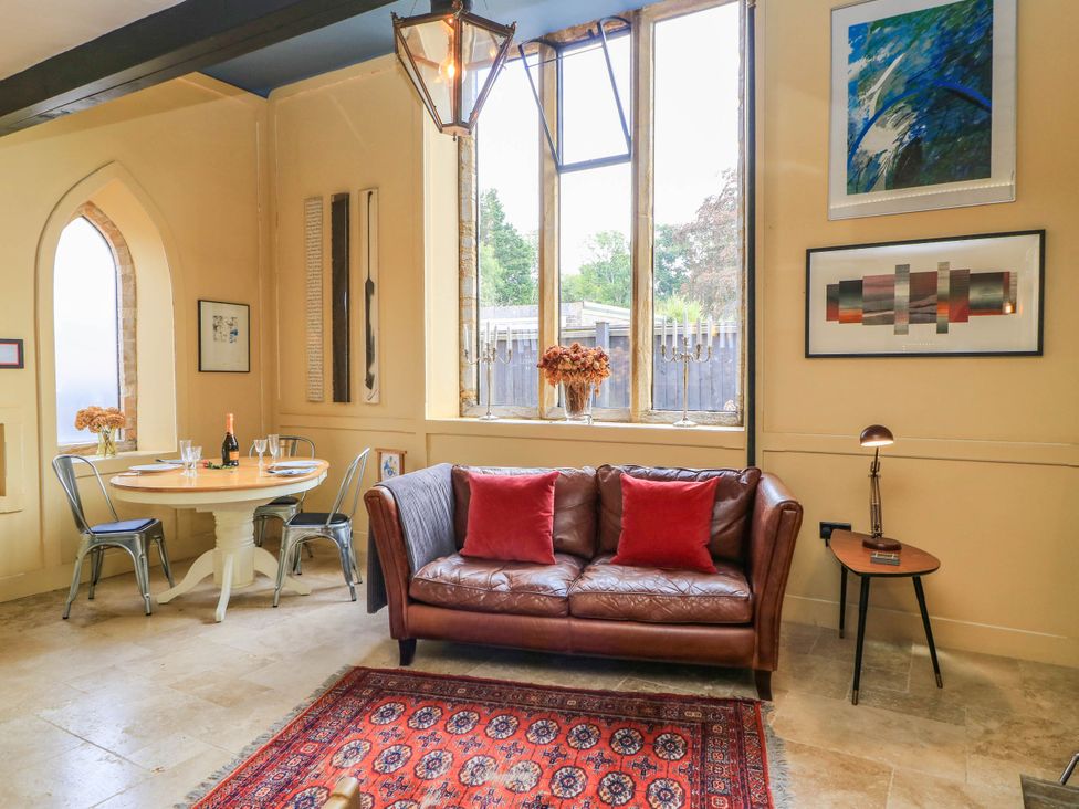 A living room with a sofa and dining table at The Sunday School Room in Sherborne