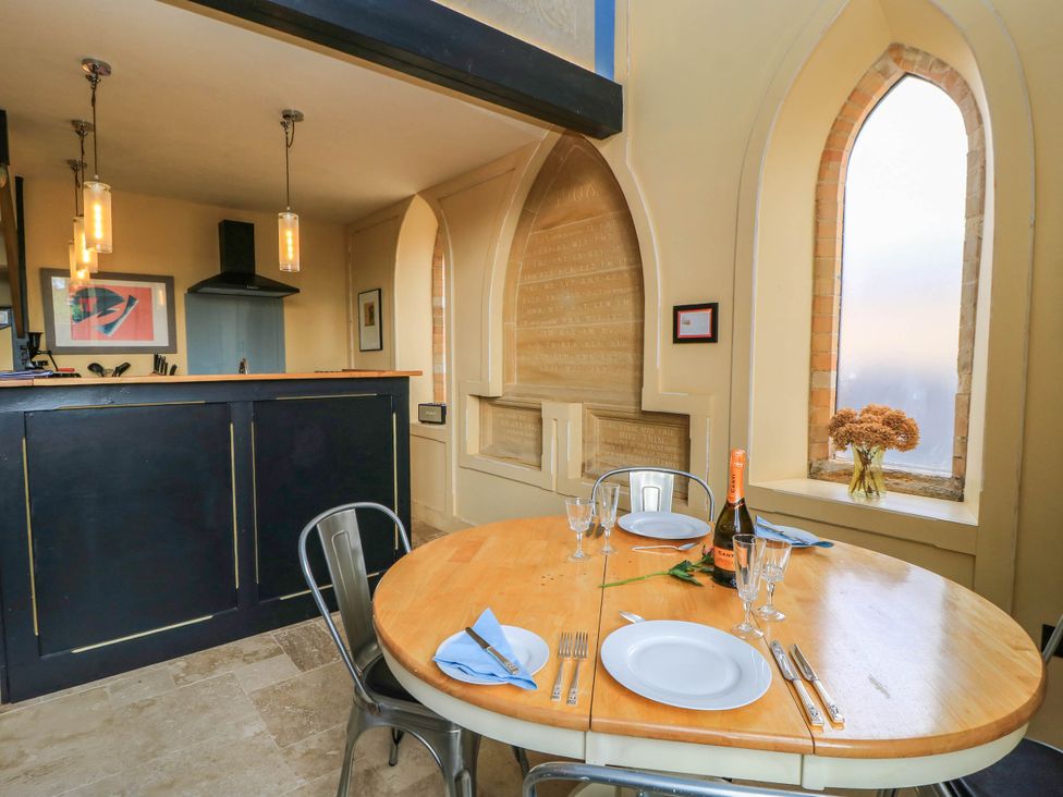A dining room with a table set for a meal at The Sunday School Room Sherborne