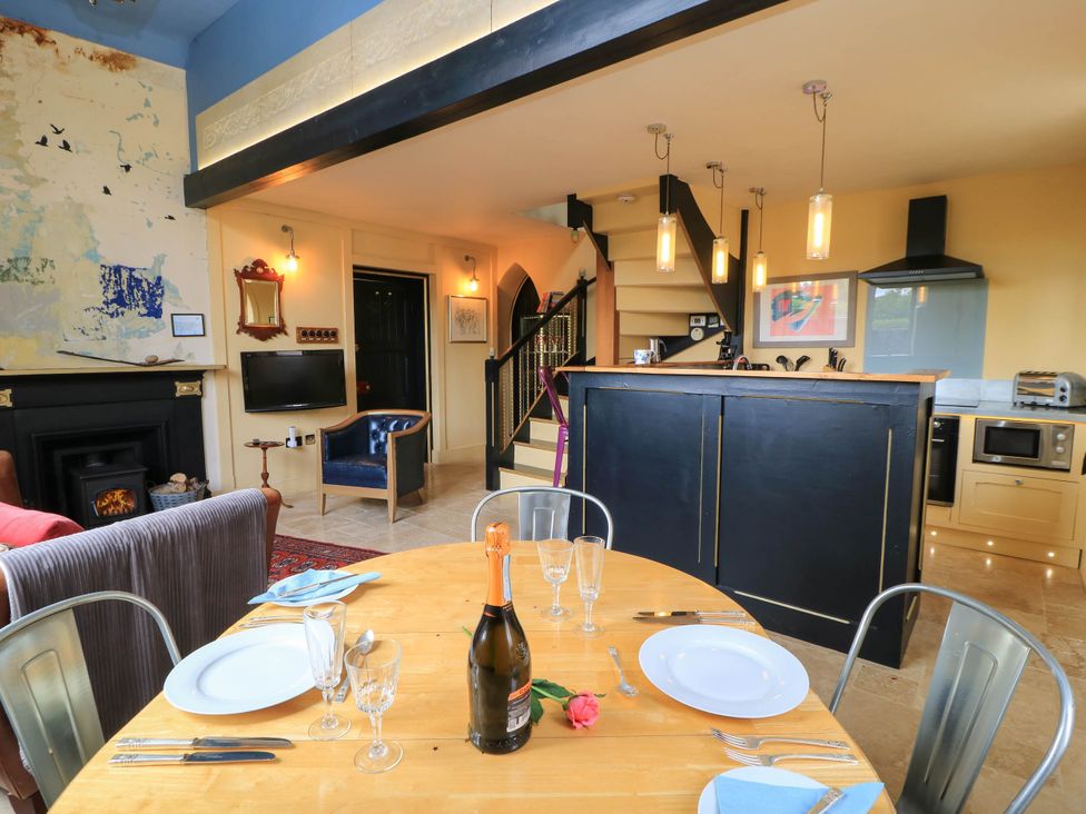 A dining room with a table set for a meal at The Sunday School Room in Sherborne