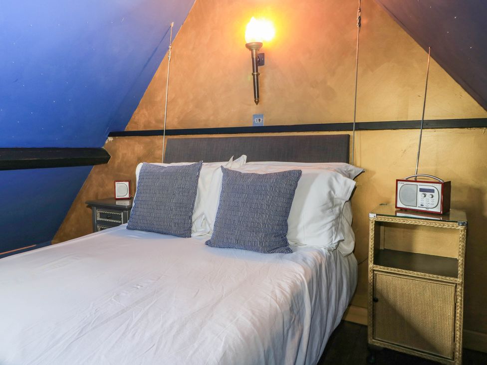 A bedroom with a bed and bedside tables at The Sunday School Room in Sherborne
