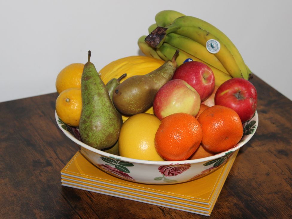 A bowl of mixed fruits on a table at Oliver Wests Apartment 1 in Scarborough