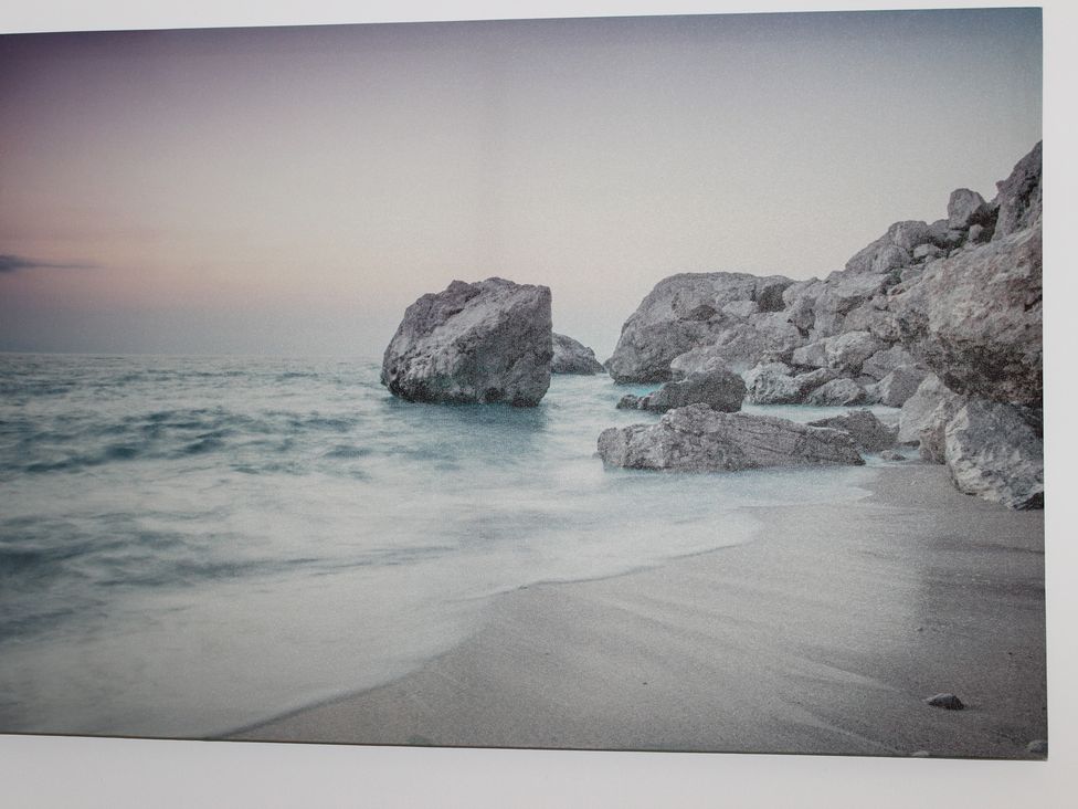 A beach with rocks and waves at Oliver Wests Apartment 1, Scarborough