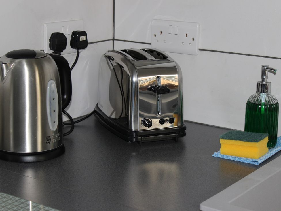 A kitchen countertop with a kettle and toaster at Oliver Wests Apartment 1 in Scarborough